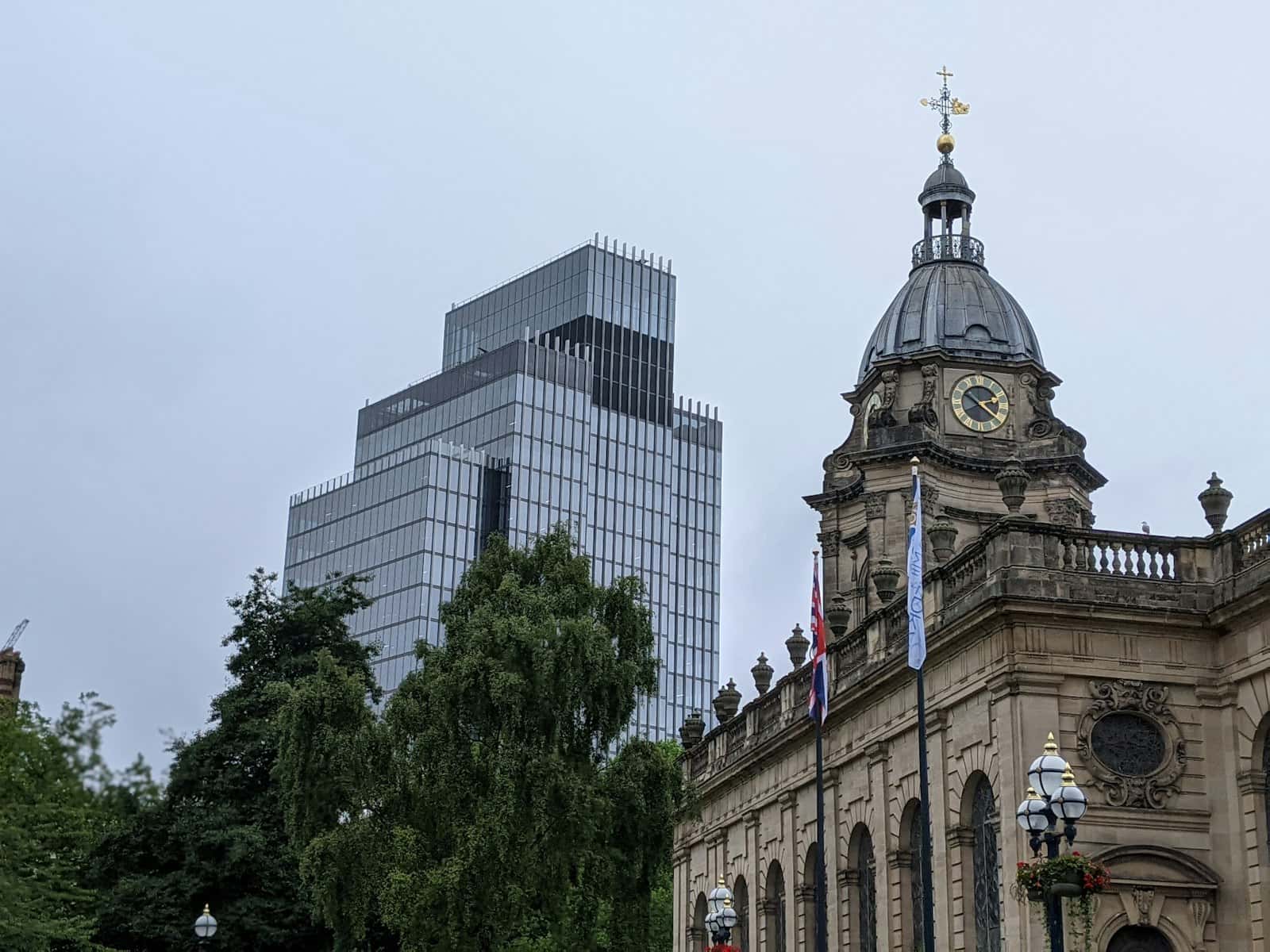 A Birmingham building beside green trees